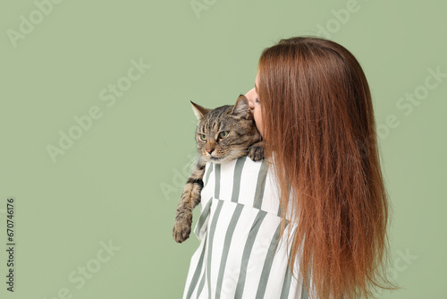 Woman with cute tabby cat o...