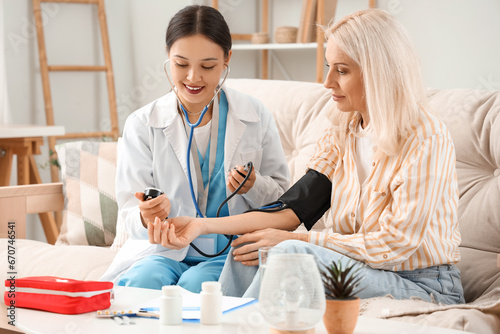 Female doctor measuring blo...