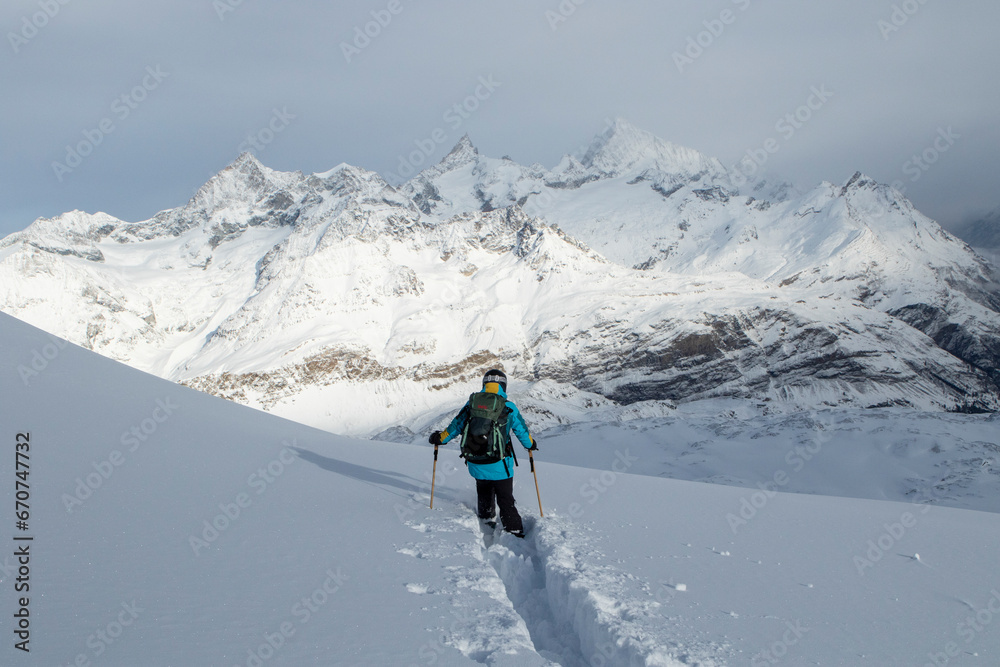 Anonymous person descending snowcapped mountain Anonymous person descending snowcapped mountain