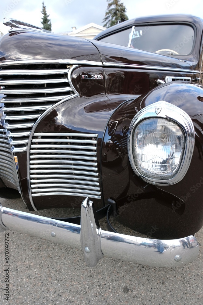 Chrome radiator grille and headlight of the retro car 