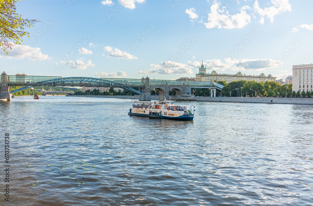 View of the Moscow river embakment, Pushkinsky bridge and cruise ships at sunset. View of the Moscow river embakment, Pushkinsky bridge and cruise ships at sunset.