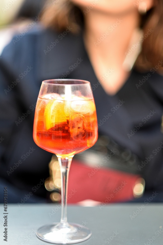 a woman sitting behind an ice cream soda with a cocktail in it a woman sitting behind an ice cream soda with a cocktail in it