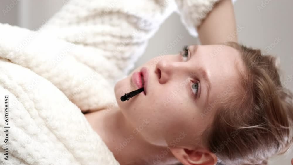 Vertical video. Beauty routine. Hair accessory. Morning spa. Relaxed confident blonde woman with clean pretty face skin tying bun with pin. Vertical video. Beauty routine. Hair accessory. Morning spa. Relaxed confident blonde woman with clean pretty face skin tying bun with pin.