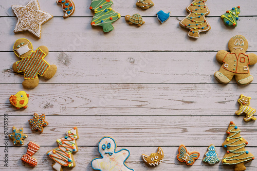 Ornament of colorful glazed Christmas cookies on a light wooden background
