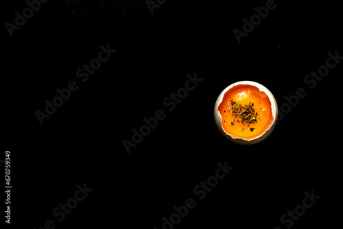 Egg in shell with dark background.