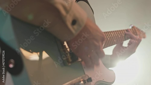Close up shot of hands of musician playing electric guitar on rehearsal