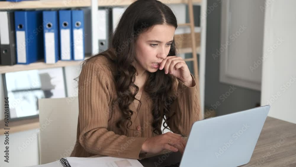 Diligent Caucasian freelancer at home orchestrates tasks, seamlessly navigating between papers and laptop. Her focused expression radiates professionalism as she expertly manages freelance work. Diligent Caucasian freelancer at home orchestrates tasks, seamlessly navigating between papers and laptop. Her focused expression radiates professionalism as she expertly manages freelance work.