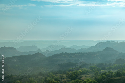 Foggy and Smoky Blue Layers of Hills and Mountains Receding into the Distance, Theodore Roosevelt National Park, Badlands, Medora, North Dakota photo
