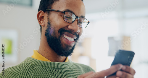 Happy, black man and phone text at house with smile from social media scroll and internet in a home. Mobile networking, male person and happy with app and blog search for online shopping and message