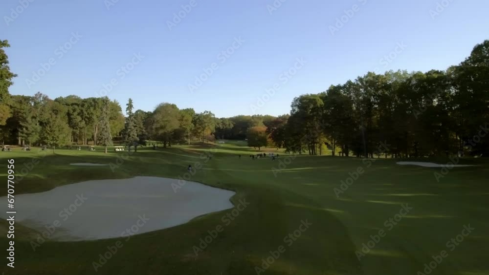 Aerial Ascending Forward Shot Of People Playing At Golf Course Against Sky - Manhasset, New York Aerial Ascending Forward Shot Of People Playing At Golf Course Against Sky - Manhasset, New York