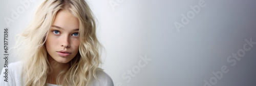 Banner of young blonde girl in studio with graduated grey background