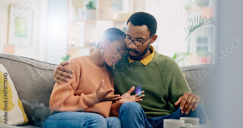 Sad, home and black couple with hug, conversation and emotions with discussion, grief and loss. People, apartment and man with woman, embrace or talking with reaction, crying and support with anxiety