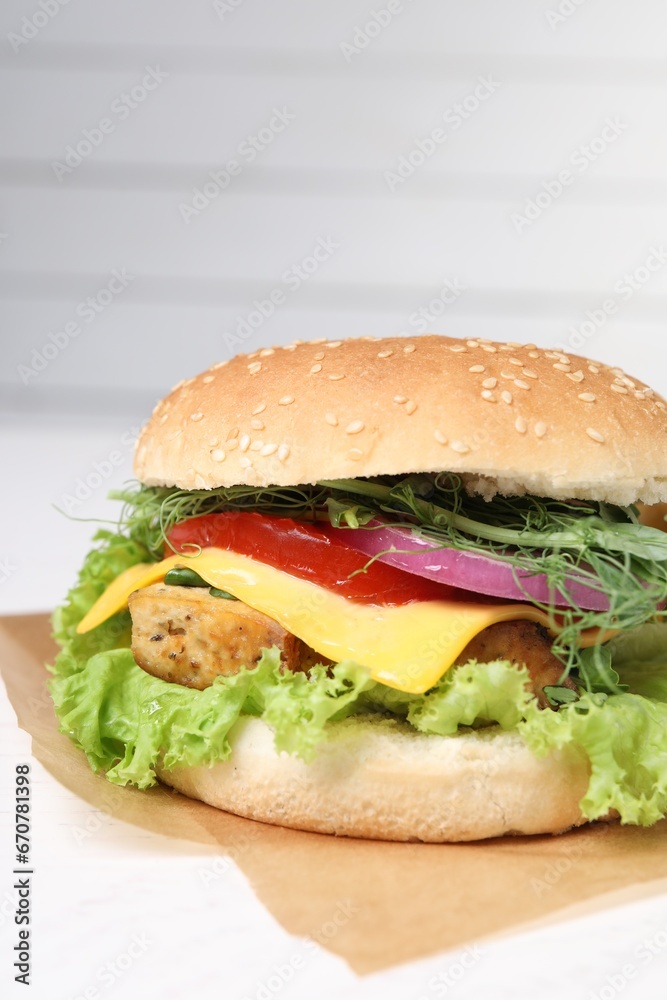Delicious burger with tofu and fresh vegetables on white table, closeup Delicious burger with tofu and fresh vegetables on white table, closeup