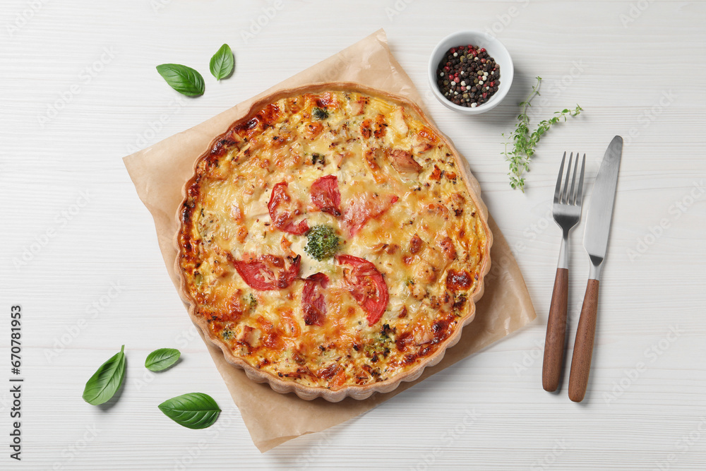 Tasty cheese quiche and cutlery on white wooden table, flat lay Tasty cheese quiche and cutlery on white wooden table, flat lay
