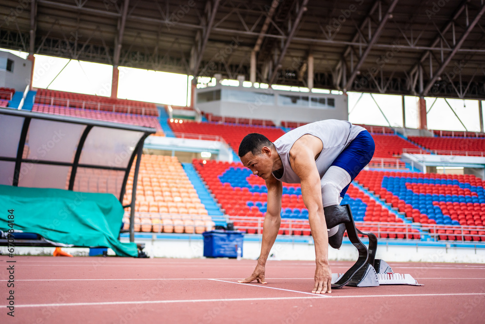 Asian para-athletes disabled with prosthetic blades running at stadium. 