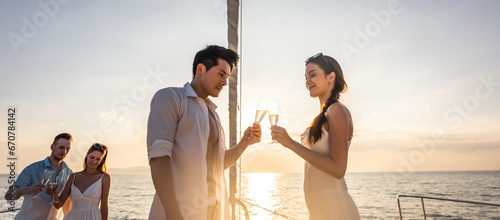 Photography Asian beautiful couple drinking champagne while having party in yacht