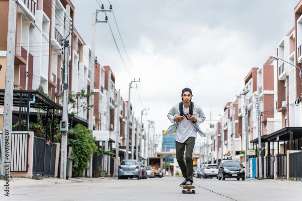 Asian young male ride surf skate board on street on the way to work. 