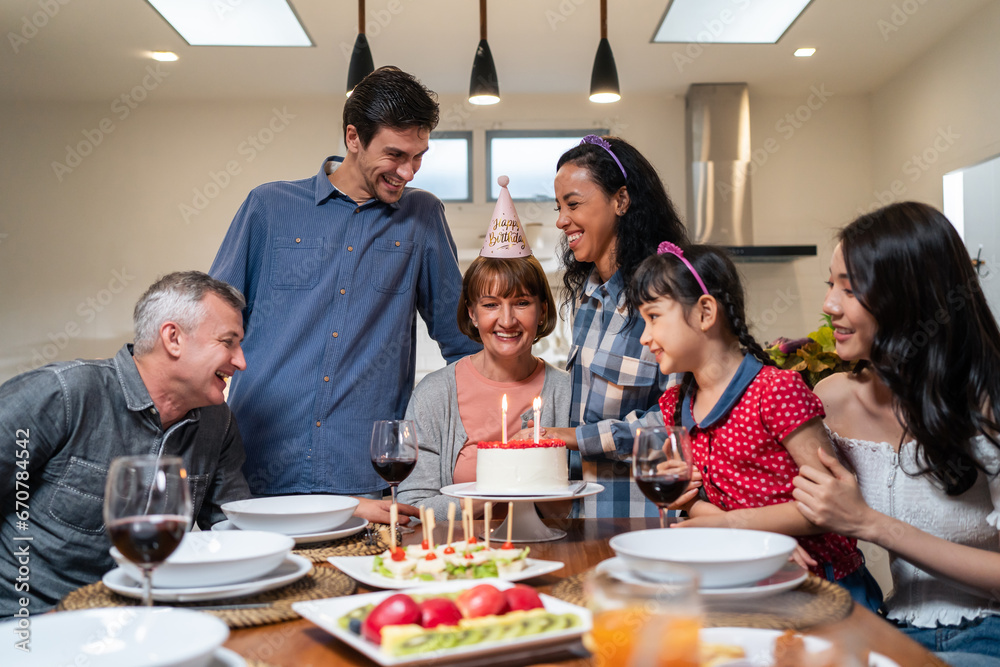 Multi-ethnic big family having birthday party for senior grandmother. Multi-ethnic big family having birthday party for senior grandmother.
