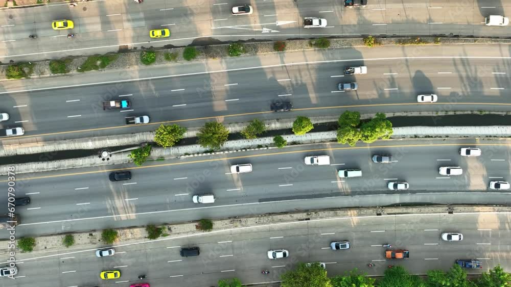 Aerial view by drone showcases the relentless stream of vehicles on the intercity motorway during peak hours, resembling a dynamic, high-speed metropolis in motion. Vehicle concept. Roads background.
Aerial view by drone showcases the relentless stream of vehicles on the intercity motorway during peak hours, resembling a dynamic, high-speed metropolis in motion. Vehicle concept. Roads background.