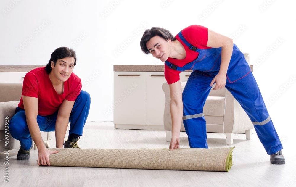 Two young contractor employees moving personal belongings Two young contractor employees moving personal belongings