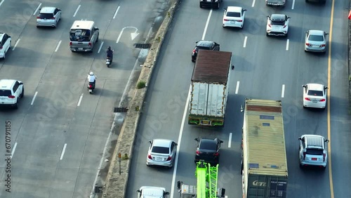 From the above, the motorway resembles a chaotic battlefield during rush hour, with vehicles locked in a fierce struggle for inches of progress. Time Loss: Delays in travel. Traffic concept. 4K.
