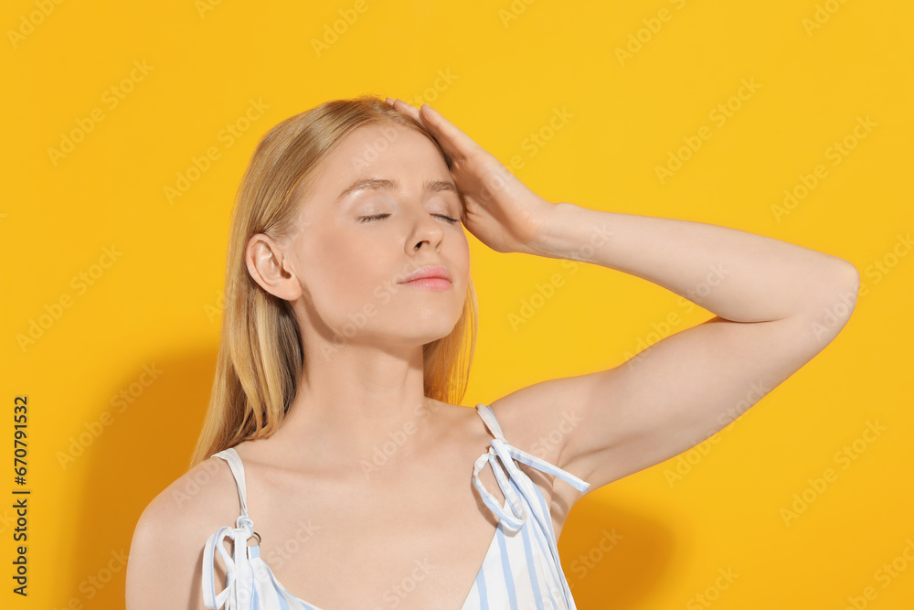 Beautiful young woman posing on orange background Beautiful young woman posing on orange background