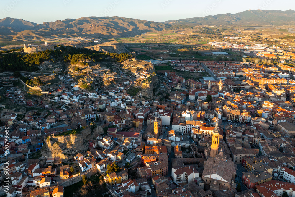 Aerial view of Spanish town of Calatayud located on scenic landscape of Sistema Iberico mountain range on sunny spring day, Province of Zaragoza