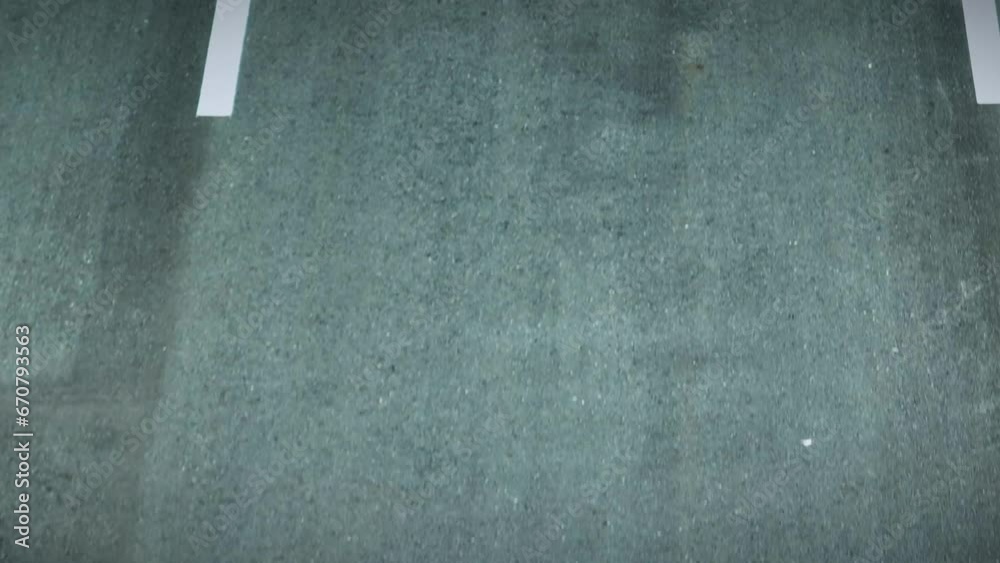 A fresh asphalt road gleams under the sunlight, its surface smooth and