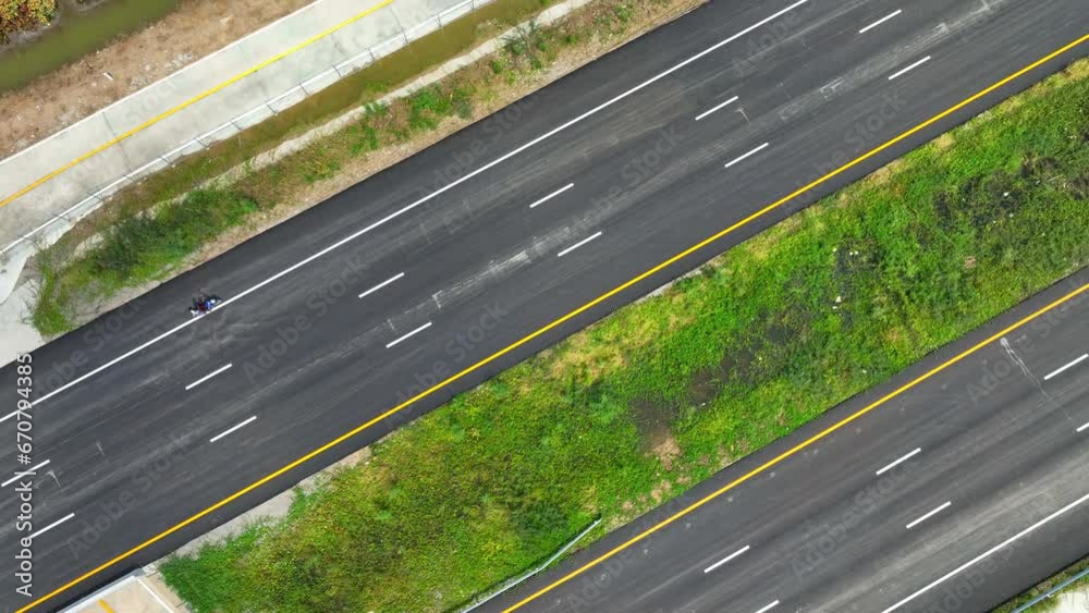 Aerial drone view : A breathtaking urban marvel unfolds - an empty intercity motorway, its flawless asphalt glistening in the drone's gaze. Transportation concept. Road background. 4K.
Aerial drone view : A breathtaking urban marvel unfolds - an empty intercity motorway, its flawless asphalt glistening in the drone's gaze. Transportation concept. Road background. 4K.