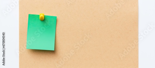 Cork board with a pinned green sticky note