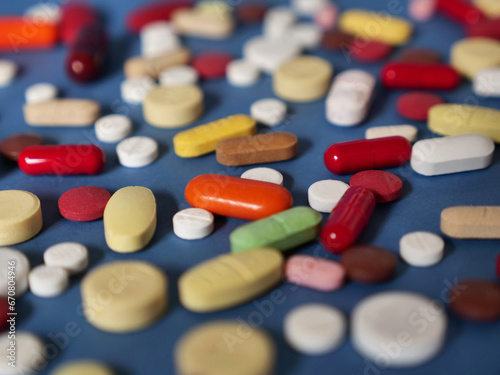 Drug medicine background, pharmaceutical pills and tablets on blue