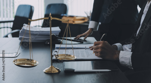 Business and lawyers discussing contract papers with brass scale on desk in office. Law, legal services, advice, justice and law concept picture with film grain effect