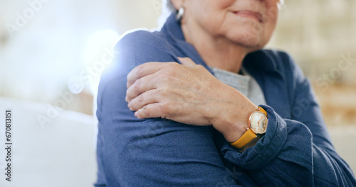 Closeup, shoulder pain and old woman with injury, accident and emergency with muscle tension, lens flare and strain. Pensioner, elderly lady or pensioner with stress, bruise and broker with arthritis photo