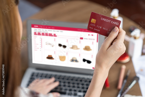 Woman shopping online on internet marketplace browsing for sale items for modern lifestyle and use credit card for online payment from wallet protected by utmost cyber security software