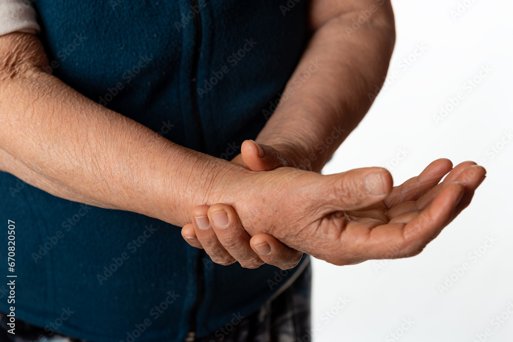 Fototapeta premium Wrist pain. Older woman holding her wrist because of severe pain. Tendinitis concept.