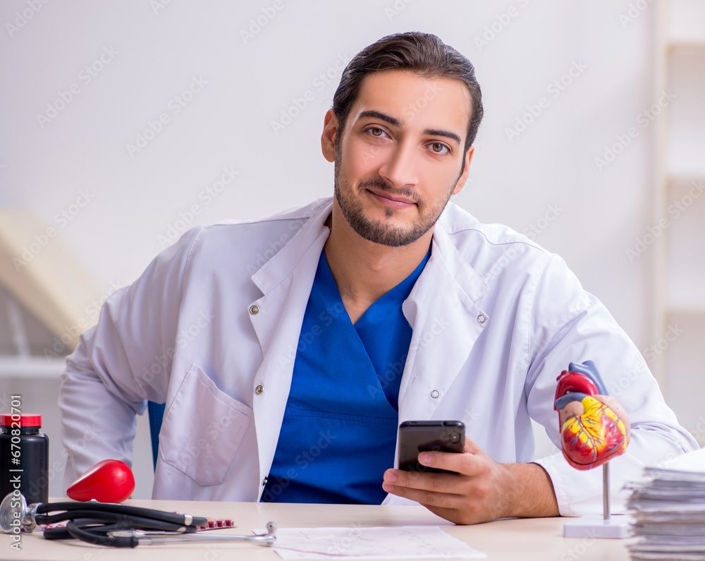 Young male doctor cardiologist working in the clinic Young male doctor cardiologist working in the clinic
