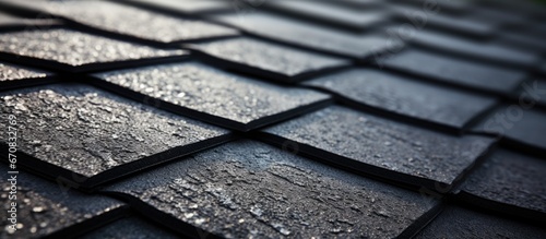 Close up of new buildings roof covered in asphalt or bitumen shingles for waterproofing