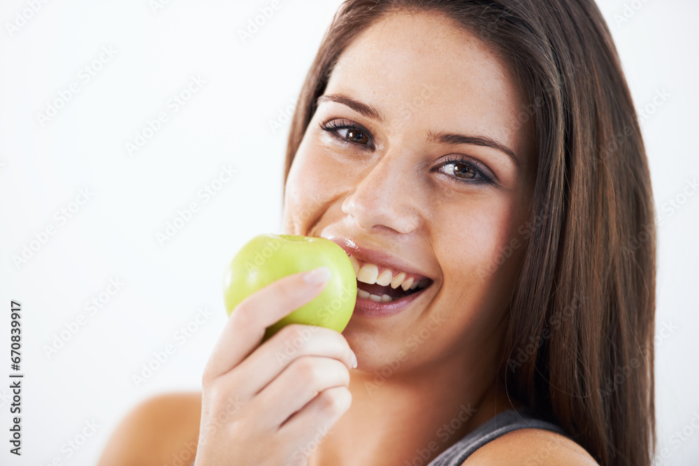 Woman, portrait and eating apple in studio for nutrition, healthy food and clean detox on white background. Face of happy model with fruits for vegan diet, vitamin c and lose weight on mockup space Woman, portrait and eating apple in studio for nutrition, healthy food and clean detox on white background. Face of happy model with fruits for vegan diet, vitamin c and lose weight on mockup space