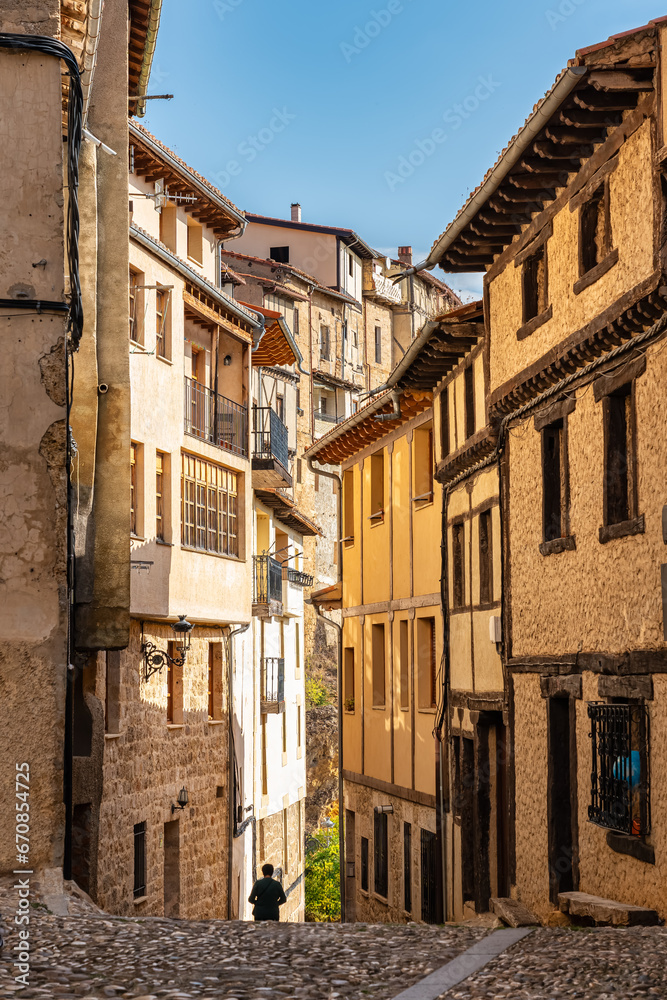 Alley with old houses and cobblestones on the ground in the picturesque village of Frias, Burgos, Spain.