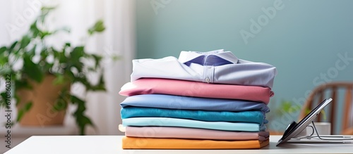 Ironed clothes on table at home photo