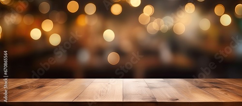 For your photo arrangement or showcasing your products utilize an empty brown wooden table as the main subject with a background featuring a blurred coffee shop or restaurant scene enhanced 