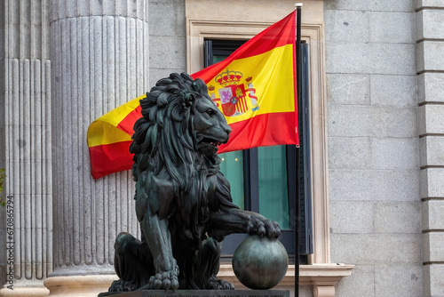 The Congress of Deputies is decked out to receive the Kings of Spain and the Princess of Asturias on their birthday. The lion of the courts next to the flag of Spain. photo