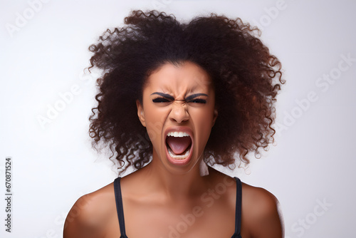 Angry young adult African American woman yelling, head and shoulders portrait on white background. Neural network generated image. Not based on any actual person or scene. photo