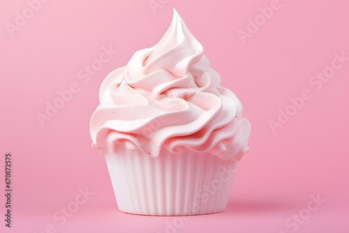 Whipped cream in cup on pink background
