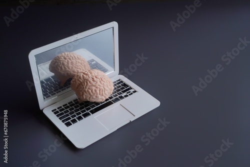 Human brain on top of laptop with copy space. Artificial intelligence concept