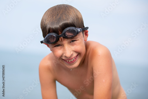 Happy child after swimming wearing swimming goggles.
