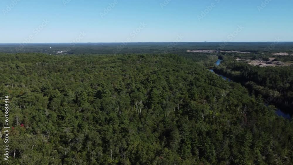 Canadian roadway winding through dense forest with distant horizon Canadian roadway winding through dense forest with distant horizon