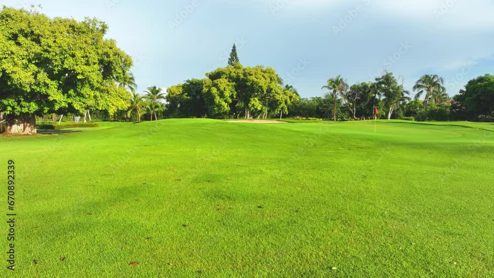 Scenic panoramic views of the golf course. Lawn with green grass. Elite outdoor recreation. Dominican bright field landscape. Green golf course next to the hotel. Vacation concept. Scenic panoramic views of the golf course. Lawn with green grass. Elite outdoor recreation. Dominican bright field landscape. Green golf course next to the hotel. Vacation concept.