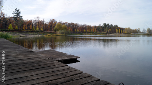 wooden bridge over lake, a gray October morning, which, however, foreshadows a pleasant, warm autumn day