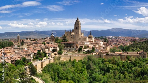 an aerial view of the town with Segovia Cathedral and mountains in spain